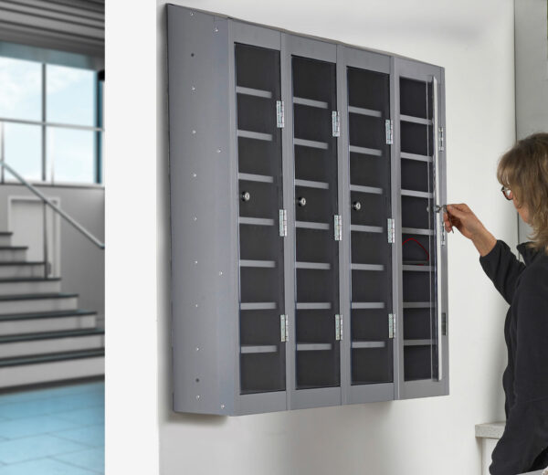 Wall mounted mobile phone lockers with a teacher unlocking them